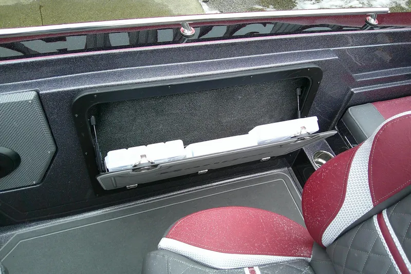 Slide: The Image of 2026 Ranger 620xFS Pro boat interior with storage compartment and red seats. - 17