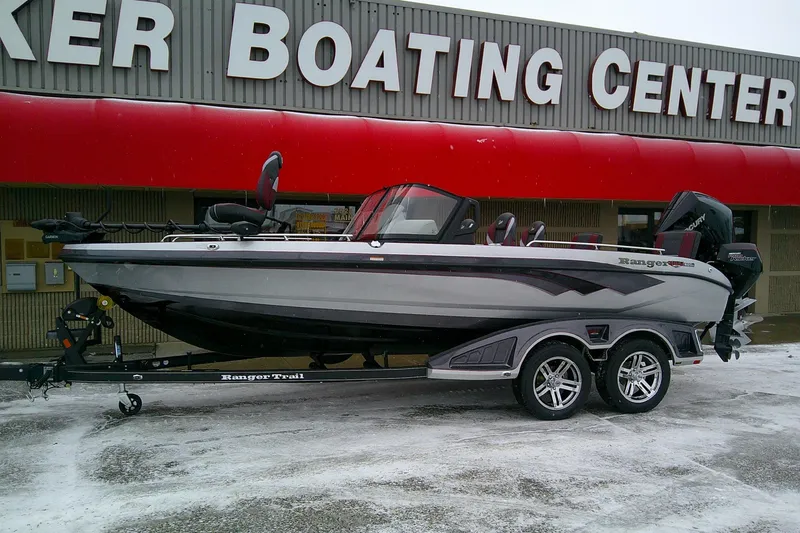 Slide: The Image of 2026 Ranger 620xFS Pro boat on trailer outside dealership in snowy weather. - 2