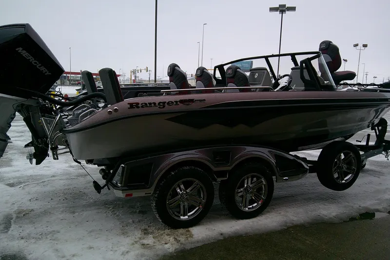 Slide: The Image of 2026 Ranger 620xFS Pro boat on trailer in snowy parking lot. - 3