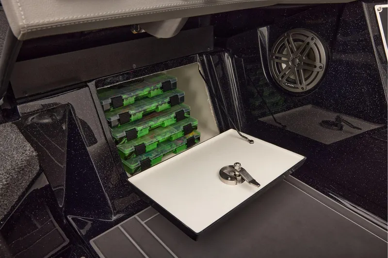 Slide: The Image of Manufacturer Provided Image: Interior storage of 2026 Ranger 620xFS Pro boat with tackle boxes and speaker. - 63