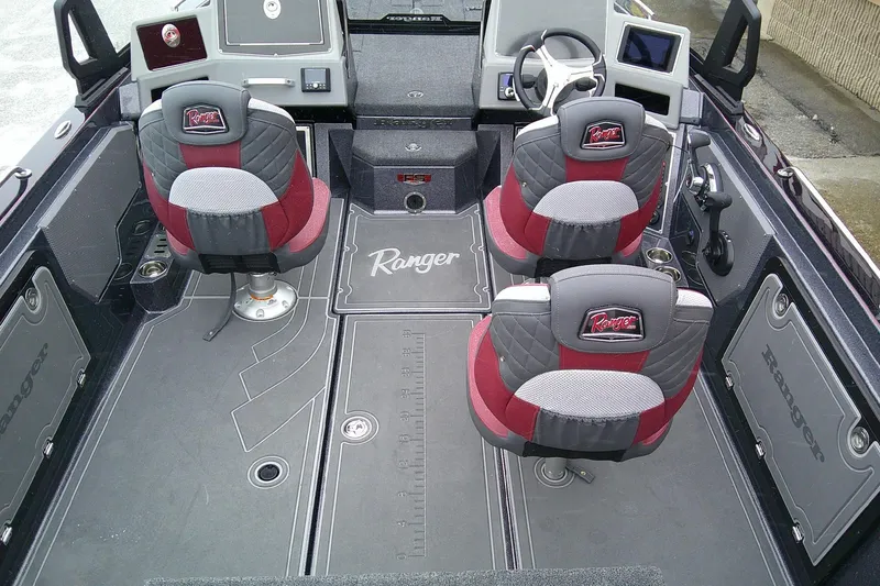 Slide: The Image of 2026 Ranger 620xFS Pro boat interior with red and gray seating, advanced dashboard, and spacious layout. - 7