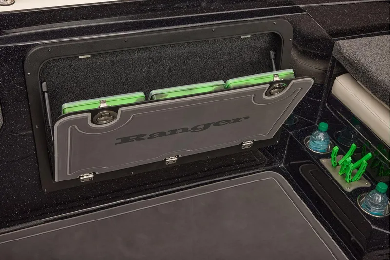 Slide: The Image of Manufacturer Provided Image: 2026 Ranger 620xFS Pro boat storage compartment with green tackle boxes and cup holders. - 73