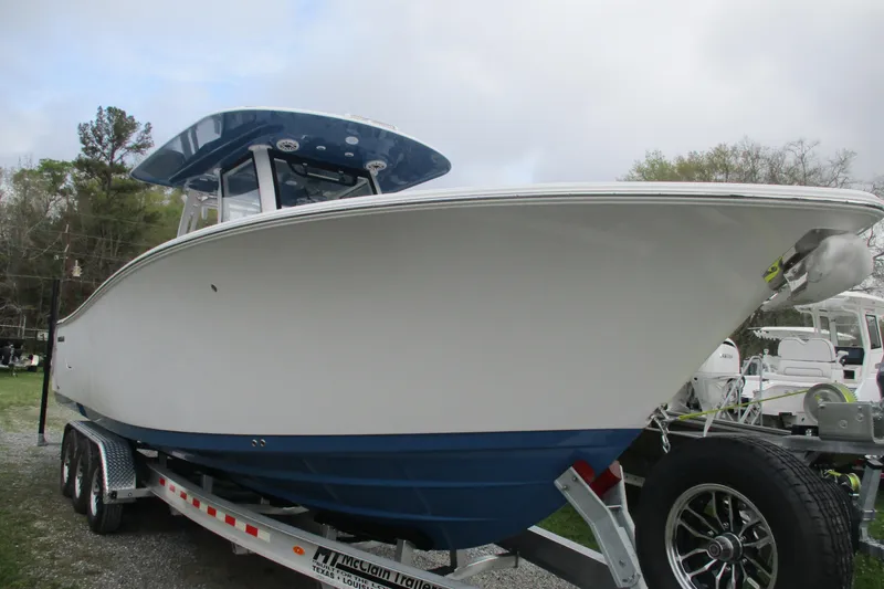 Slide: The Image of 2026 Sportsman Open 302 Center Console boat on trailer, side view. - 1