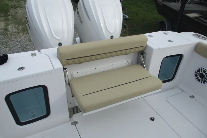 Slide: The Image of 2026 Sportsman Open 302 Center Console boat with beige seating and dual engines. - 10
