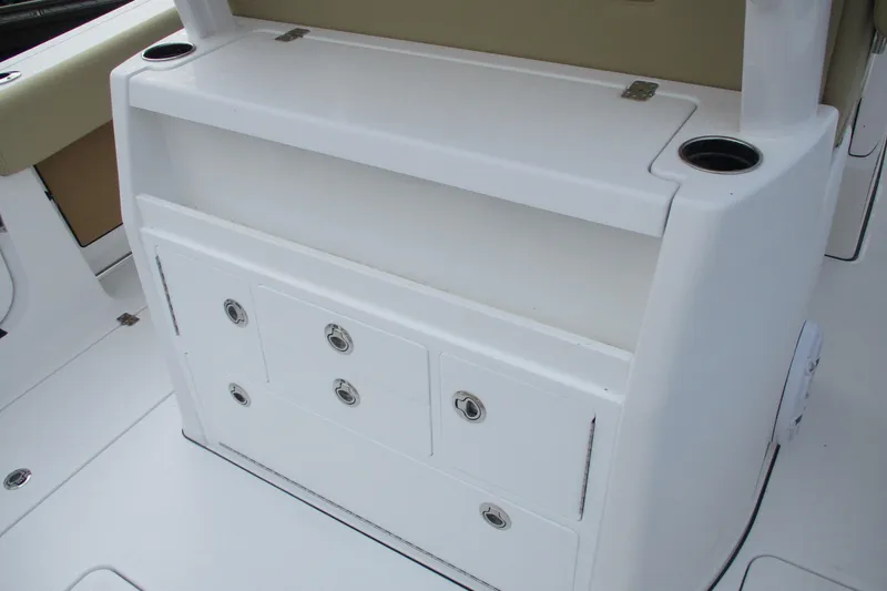 Slide: The Image of 2026 Sportsman Open 302 Center Console storage compartment with cup holders and drawers. - 11