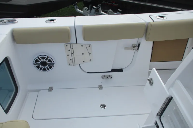 Slide: The Image of 2026 Sportsman Open 302 Center Console boat interior with seating and speaker. - 13