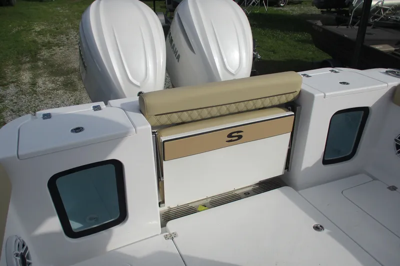 Slide: The Image of 2026 Sportsman Open 302 Center Console boat with dual Yamaha engines and cushioned seating. - 18