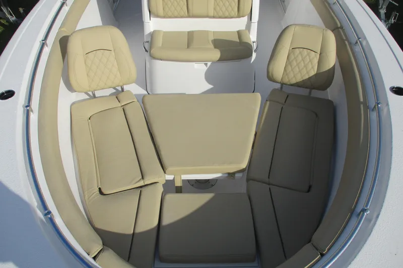 Slide: The Image of 2026 Sportsman Open 302 Center Console with beige cushioned seating arrangement. - 19