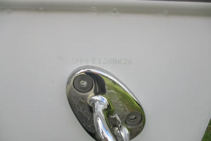 Slide: The Image of 2026 Sportsman Open 302 Center Console boat hull identification number and chrome fitting. - 23