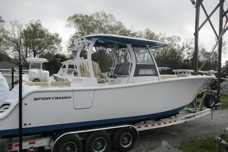 Slide: The Image of 2026 Sportsman Open 302 Center Console boat on trailer, side view. - 3