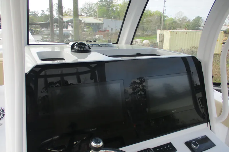 Slide: The Image of 2026 Sportsman Open 302 Center Console dashboard with navigation screens and compass. - 8