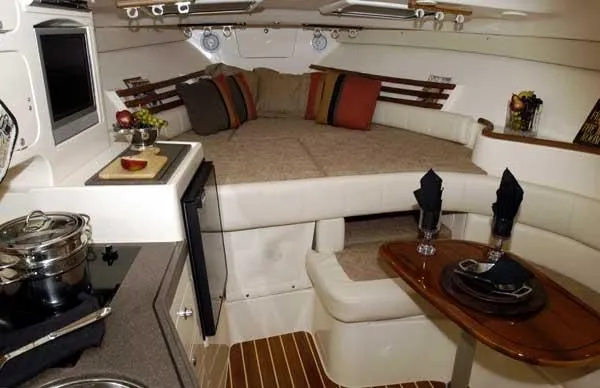 Slide: The Image of Interior of a 2005 Grady-White Express 330 yacht with cozy bed and dining area. - 7