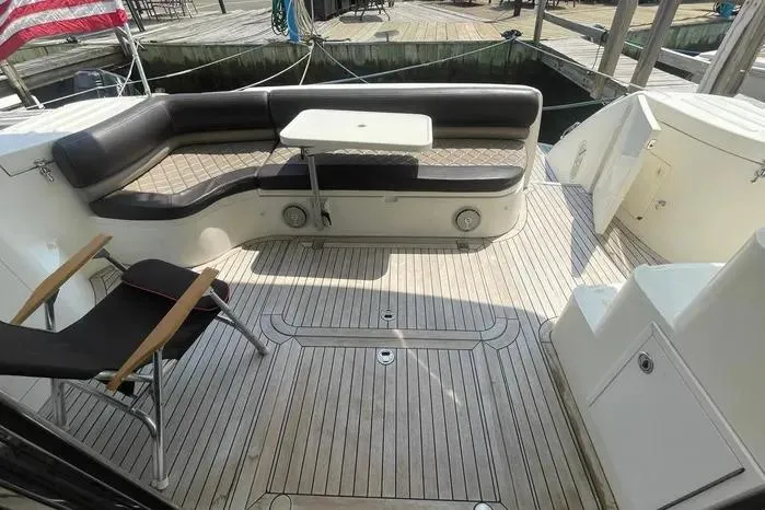 Slide: The Image of 2001 Viking Princess yacht deck with seating and table, ready for sale. - 4
