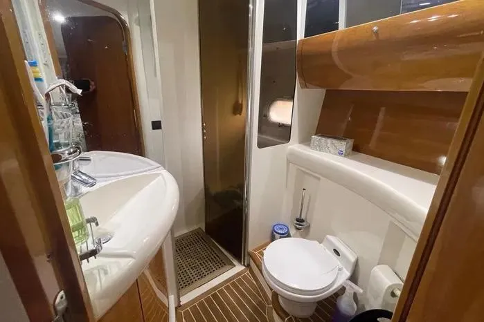 Slide: The Image of Luxurious 2001 Viking Princess yacht bathroom with modern amenities and elegant wood finishes. - 6