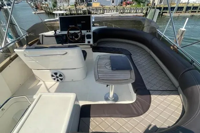 Slide: The Image of Luxurious 2001 Viking Princess yacht deck with seating, table, and helm, docked by the water. - 9