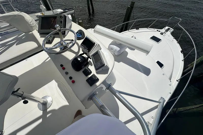 Slide: The Image of 2006 Rampage 33 Express boat helm with steering wheel and navigation equipment. - 12