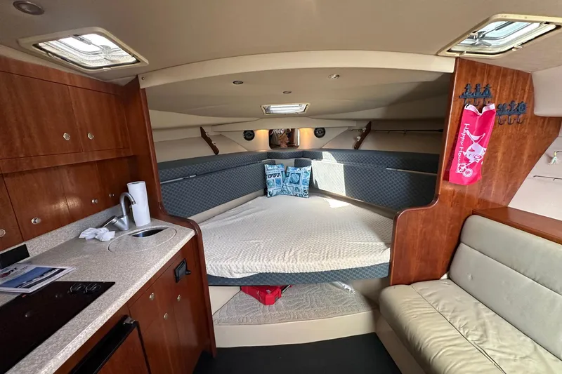 Slide: The Image of 2006 Rampage 33 Express cabin interior with kitchenette, bed, and seating area. - 14