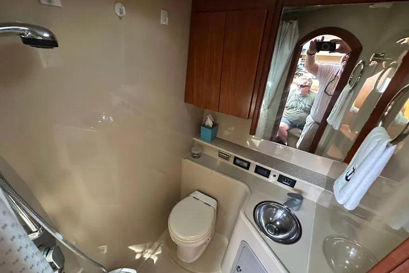 Slide: The Image of 2006 Rampage 33 Express boat bathroom with sink, toilet, and mirror reflection. - 16