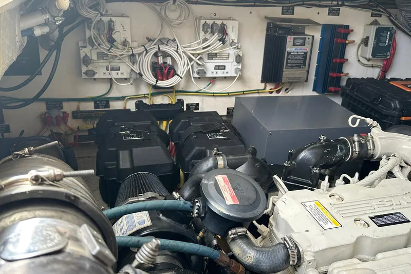 Slide: The Image of Engine room of a 2006 Rampage 33 Express boat, showcasing wiring and mechanical components. - 18