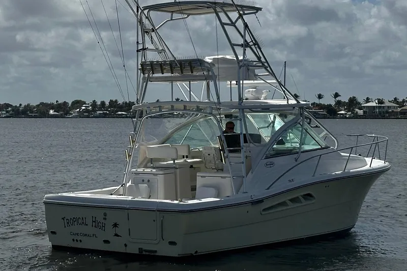 Slide: The Image of 2006 Rampage 33 Express boat on water, featuring a tower and spacious deck. - 2
