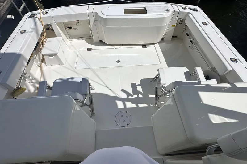 Slide: The Image of 2006 Rampage 33 Express boat deck with seating and storage compartments. - 6