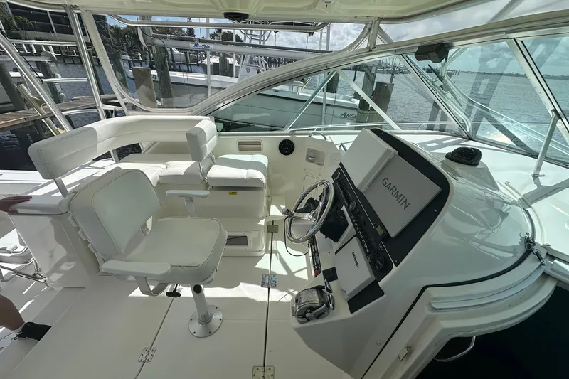 Slide: The Image of 2006 Rampage 33 Express boat helm with Garmin navigation system and white seating. - 8