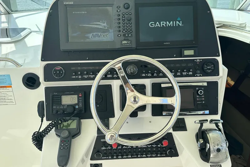 Slide: The Image of Helm of 2006 Rampage 33 Express with Garmin and Furuno navigation systems. - 9