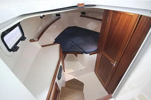 Slide: The Image of Manufacturer Provided Image: 2026 NorthCoast 315 HT cabin interior with wood accents and cozy sleeping area. - 14