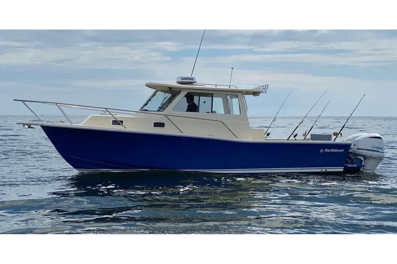 Slide: The Image of Manufacturer Provided Image: 2026 NorthCoast 315 HT boat on open water, featuring a sleek blue and white design. - 3