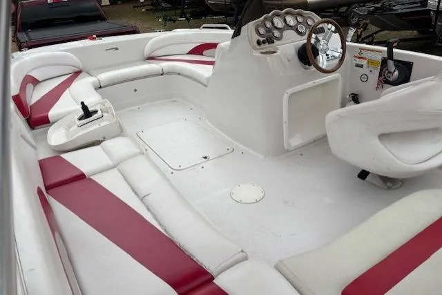 Slide: The Image of 2011 Glastron DS 205 boat interior with red and white seating and control panel. - 2