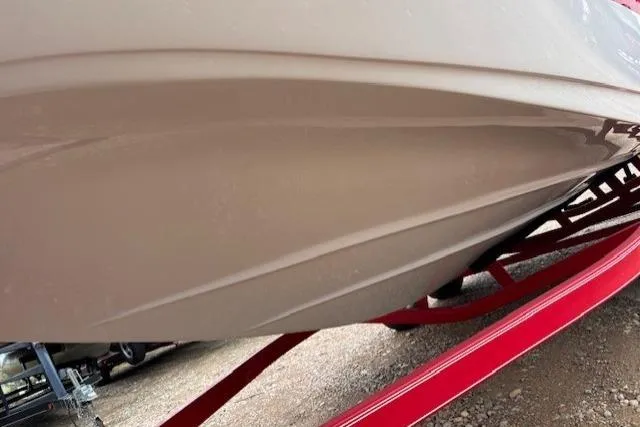 Slide: The Image of 2011 Glastron DS 205 boat hull on red trailer, close-up view. - 5