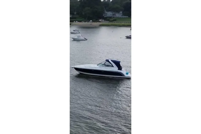 The Image of 2004 Formula 37 Performance Cruiser on calm water near shoreline. - 0