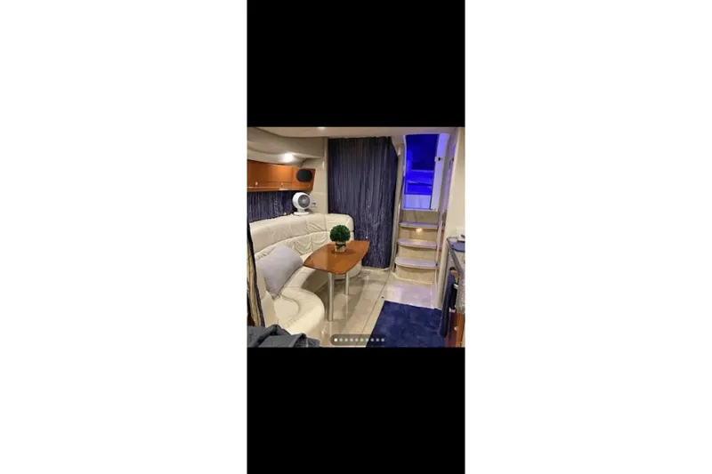 Slide: The Image of Interior of 2004 Formula 37 Performance Cruiser with seating, table, and stairs. - 10