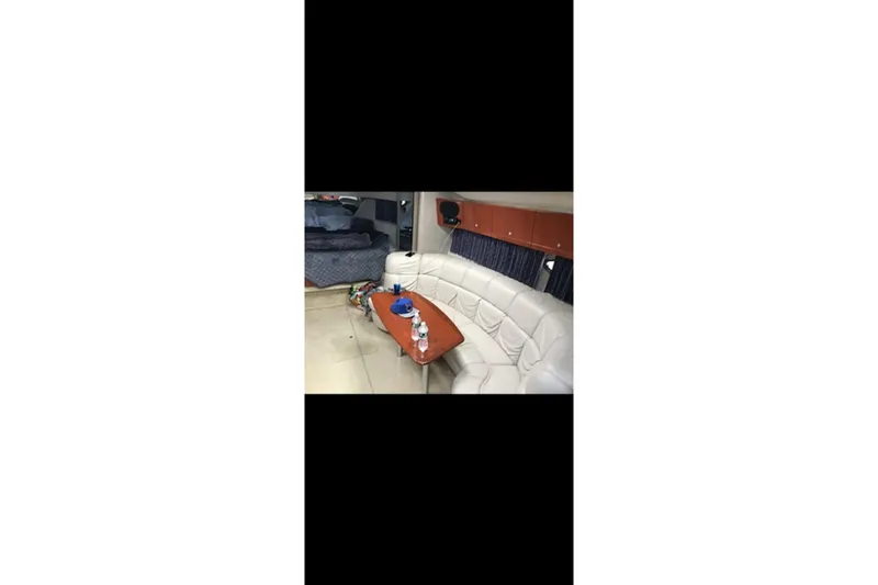 Slide: The Image of Interior of 2004 Formula 37 Performance Cruiser with white seating and wooden table. - 11