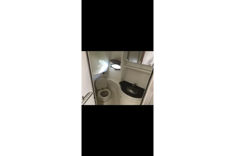 Slide: The Image of 2004 Formula 37 Performance Cruiser bathroom with toilet and sink. - 14