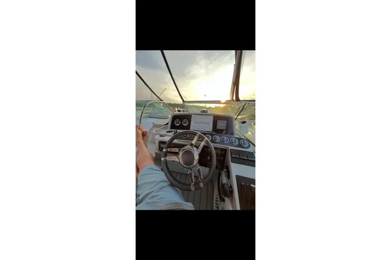 Slide: The Image of 2004 Formula 37 Performance Cruiser helm with sunset view, featuring Garmin navigation. - 5