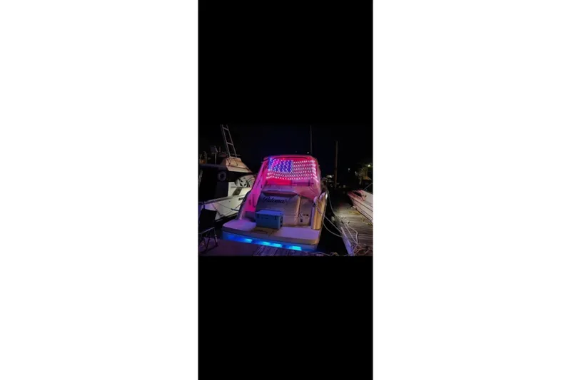 Slide: The Image of 2004 Formula 37 Performance Cruiser with vibrant LED lights at night. - 7