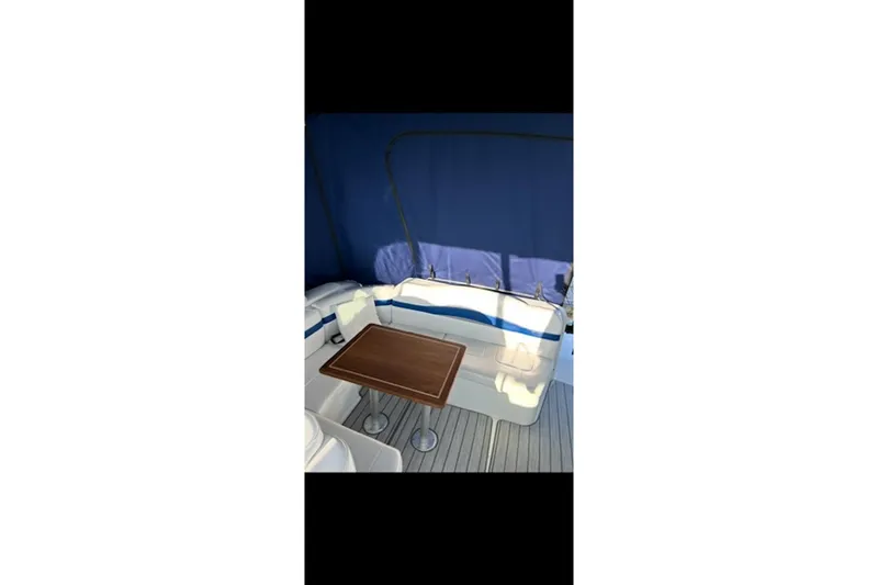 Slide: The Image of 2004 Formula 37 Performance Cruiser interior with seating and wooden table. - 8