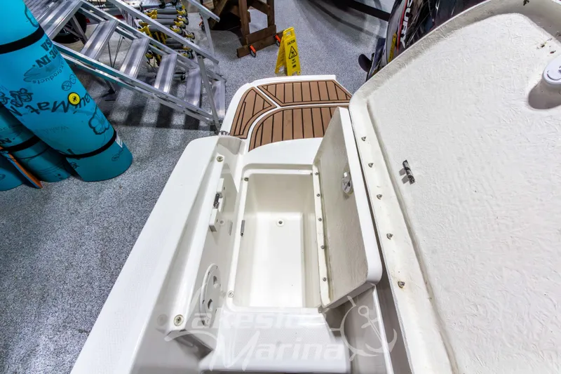 Slide: The Image of 2022 Bayliner VR5 Bowrider OB storage compartment open, showcasing interior space. - 13