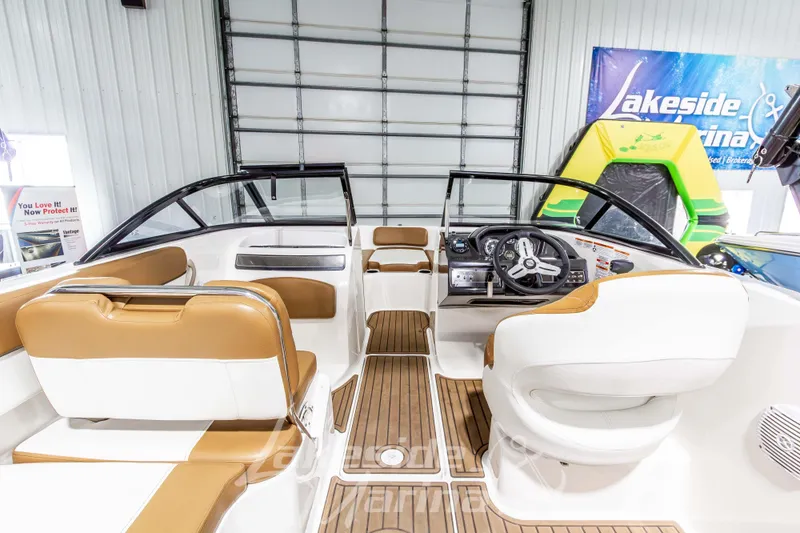 Slide: The Image of 2022 Bayliner VR5 Bowrider OB interior with tan and white seating, modern dashboard. - 15
