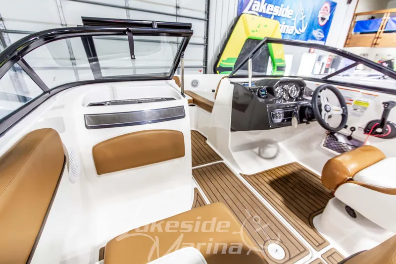 Slide: The Image of 2022 Bayliner VR5 Bowrider OB interior with tan seating and modern dashboard. - 18