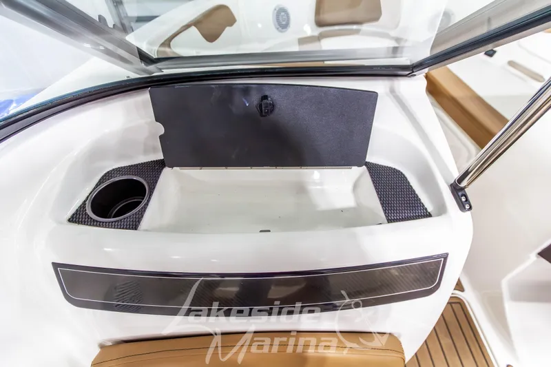 Slide: The Image of 2022 Bayliner VR5 Bowrider OB interior with storage compartment and cup holder. - 19