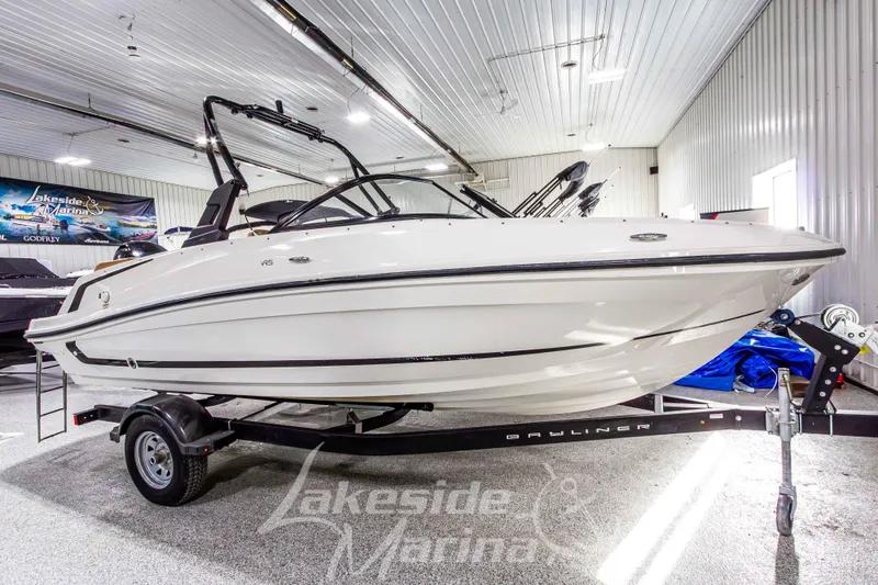 Slide: The Image of 2022 Bayliner VR5 Bowrider OB displayed indoors on a trailer. - 7