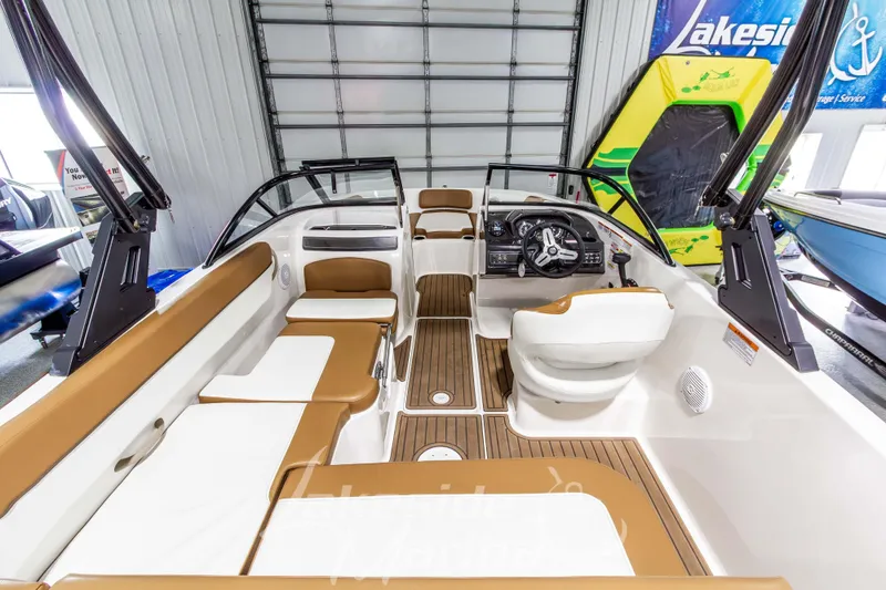 Slide: The Image of 2022 Bayliner VR5 Bowrider OB interior with tan seating and modern dashboard. - 9
