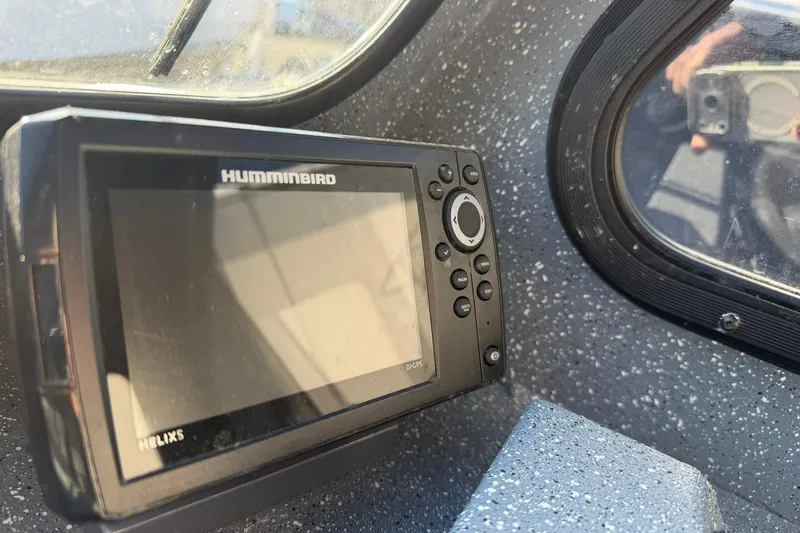 Slide: The Image of Humminbird Helix 5 fish finder on 2016 Raider 182 Pro Sport boat dashboard. - 11