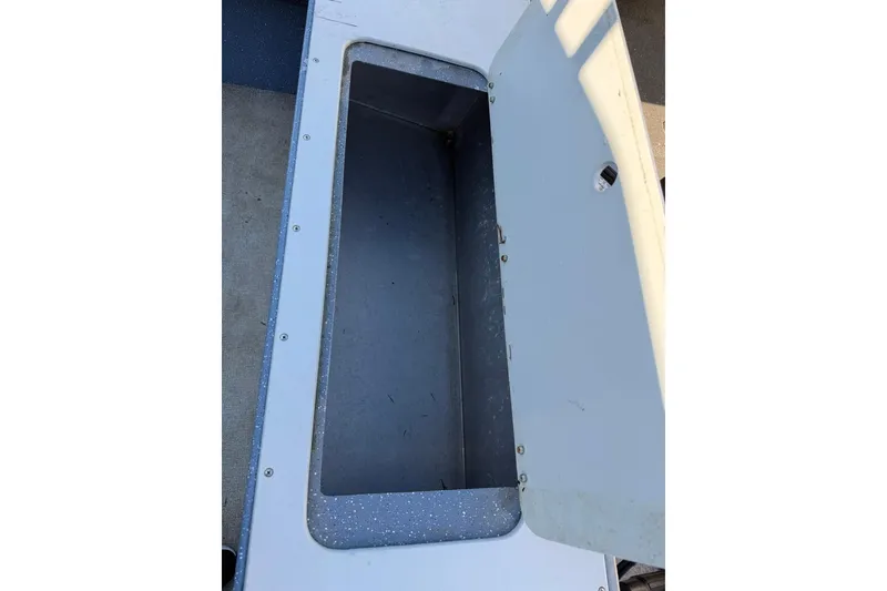 Slide: The Image of Open storage compartment on 2016 Raider 182 Pro Sport boat, showcasing interior space. - 13