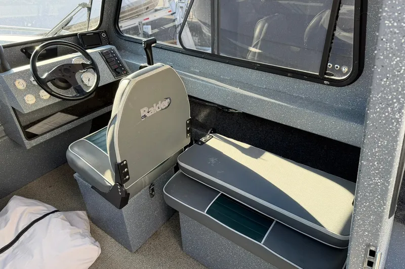 Slide: The Image of Interior of 2016 Raider 182 Pro Sport boat with steering wheel and seating. - 8
