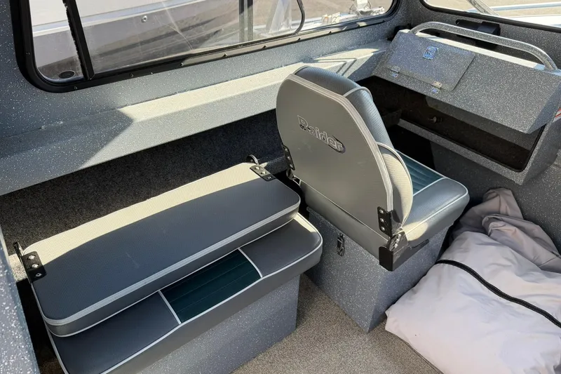 Slide: The Image of Interior of 2016 Raider 182 Pro Sport boat with seating and storage compartments. - 9