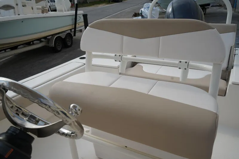 Slide: The Image of 2020 Robalo 226 Cayman boat interior with beige and white seating. - 11