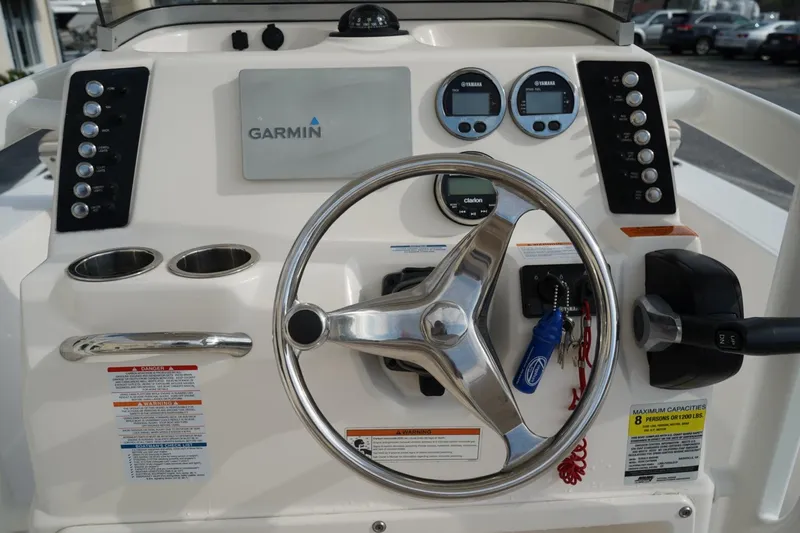 Slide: The Image of 2020 Robalo 226 Cayman boat dashboard with Garmin display and steering wheel. - 14